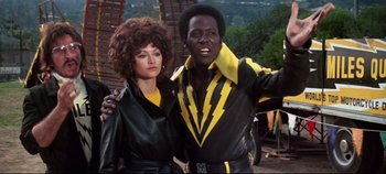 Movie still from “Earthquake” (1974), directed by Mark Robson – A man and a woman posing for a picture; Medium shot, Low angle