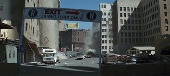 Movie still from “Earthquake” (1974), directed by Mark Robson – A street scene with a sign that says exit right turn only; Extreme Wide shot, High angle