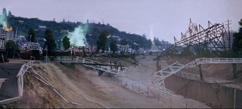 Movie still from “Earthquake” (1974), directed by Mark Robson – A view of a construction site with a green smoke coming out of it; Extreme Wide shot, High angle