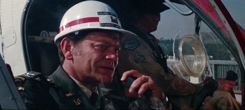 Movie still from “Earthquake” (1974), directed by Mark Robson – A person wearing a helmet; Close Up shot, Over the shoulder angle