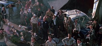 Movie still from “Earthquake” (1974), directed by Mark Robson – A large group of people standing around a body of water; Wide shot, High angle