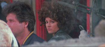 Movie still from “Earthquake” (1974), directed by Mark Robson – A young woman with a large curly hair wig; Close Up shot, Over the shoulder angle