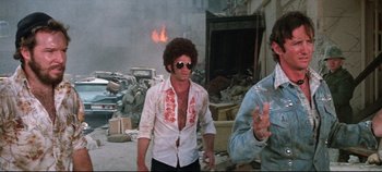 Movie still from “Earthquake” (1974), directed by Mark Robson – A man in a white shirt is walking in the street; Medium shot, Low angle