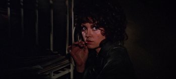 Movie still from “Earthquake” (1974), directed by Mark Robson – A woman in a leather jacket is smoking a cigarette; Close Up shot, Low angle