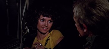 Movie still from “Earthquake” (1974), directed by Mark Robson – A woman with a yellow t - shirt is talking to a man; Close Up shot, Over the shoulder angle