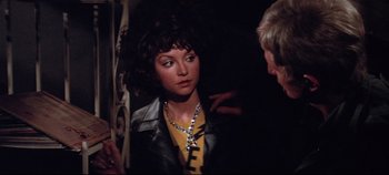 Movie still from “Earthquake” (1974), directed by Mark Robson – A woman in a yellow shirt and a man in a black jacket; Close Up shot, Over the shoulder angle