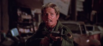 Movie still from “Earthquake” (1974), directed by Mark Robson – A man holding a gun in his mouth; Close Up shot, Low angle