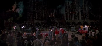 Movie still from “Earthquake” (1974), directed by Mark Robson – A group of people standing in front of a crowd of onlookers; Extreme Wide shot, High angle