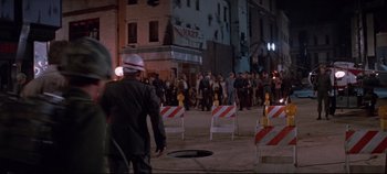 Movie still from “Earthquake” (1974), directed by Mark Robson – A group of people standing around a hole in the ground; Wide shot, High angle