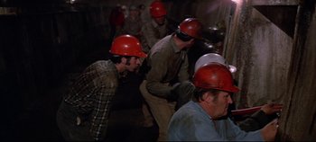 Movie still from “Earthquake” (1974), directed by Mark Robson – A group of men wearing hard hats and working hard; Medium shot, High angle
