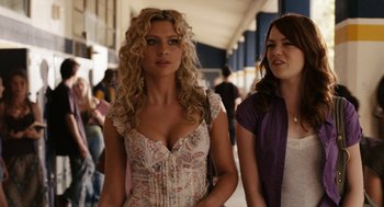 Movie still from “Easy A” (2010), directed by Will Gluck – Two women standing next to each other in a building; Close Up shot, Over the shoulder angle