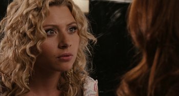 Movie still from “Easy A” (2010), directed by Will Gluck – A person with curly hair looking at a mirror; Close Up shot, Over the shoulder angle
