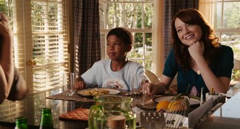 Movie still from “Easy A” (2010), directed by Will Gluck – Two people sitting at a table with plates of food on it; Medium shot, Over the shoulder angle