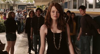 Movie still from “Easy A” (2010), directed by Will Gluck – A group of people walking down a sidewalk; Medium shot, Over the shoulder angle