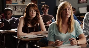 Movie still from “Easy A” (2010), directed by Will Gluck – Two women and a man sitting at desks in a class room; Medium shot, Over the shoulder angle