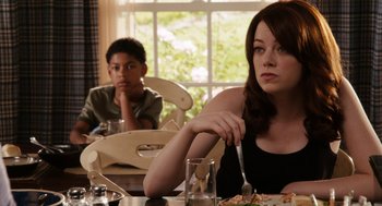 Movie still from “Easy A” (2010), directed by Will Gluck – A woman sitting at a table with a boy in front of her; Medium shot, Over the shoulder angle