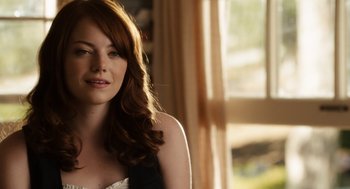 Movie still from “Easy A” (2010), directed by Will Gluck – A beautiful woman with long red hair wearing a black dress; Close Up shot, Over the shoulder angle
