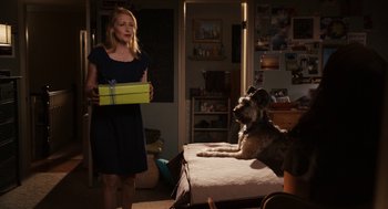 Movie still from “Easy A” (2010), directed by Will Gluck – A woman standing in front of a bed with a dog; Medium shot, Over the shoulder angle