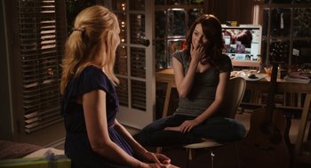 Movie still from “Easy A” (2010), directed by Will Gluck – Two women are sitting in a room talking; Medium shot, Over the shoulder angle