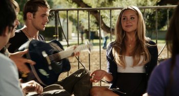Movie still from “Easy A” (2010), directed by Will Gluck – A man and a woman sitting next to each other on a bench; Medium shot, Over the shoulder angle