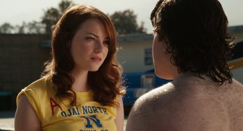 Movie still from “Easy A” (2010), directed by Will Gluck – A woman in a yellow shirt is talking to a man; Close Up shot, Over the shoulder angle