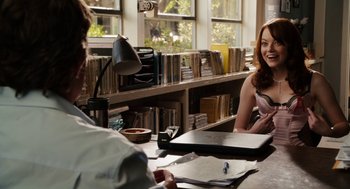Movie still from “Easy A” (2010), directed by Will Gluck – Two people sitting at a table in front of a laptop computer; Medium shot, Over the shoulder angle
