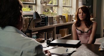 Movie still from “Easy A” (2010), directed by Will Gluck – A woman sitting at a table in front of a man; Medium shot, Over the shoulder angle