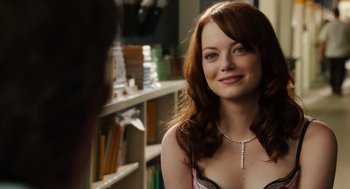 Movie still from “Easy A” (2010), directed by Will Gluck – A beautiful young woman with long red hair; Close Up shot, Over the shoulder angle