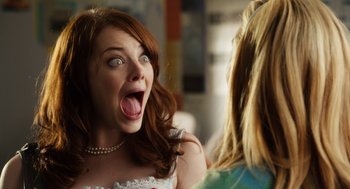 Movie still from “Easy A” (2010), directed by Will Gluck – A woman in a white dress is making a funny face; Close Up shot, Over the shoulder angle
