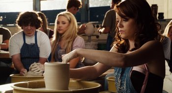 Movie still from “Easy A” (2010), directed by Will Gluck – A woman is working on a pottery wheel; Medium shot, Over the shoulder angle
