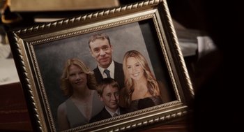 Movie still from “Easy A” (2010), directed by Will Gluck – A picture of a family in a picture frame on a table; Extreme Close Up shot, Overhead angle
