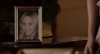 Movie still from “Easy A” (2010), directed by Will Gluck – A picture frame with a picture of a woman in it; Extreme Close Up shot, High angle