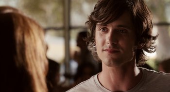 Movie still from “Easy A” (2010), directed by Will Gluck – A person wearing a white shirt; Close Up shot, Over the shoulder angle