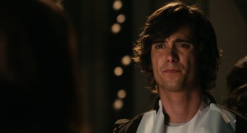 Movie still from “Easy A” (2010), directed by Will Gluck – A man with long brown hair looking at the camera; Close Up shot, Over the shoulder angle