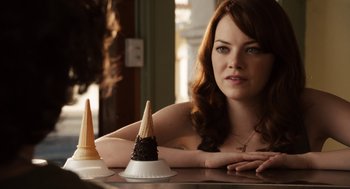 Movie still from “Easy A” (2010), directed by Will Gluck – A woman sitting at a table with two cones of ice cream; Close Up shot, Over the shoulder angle