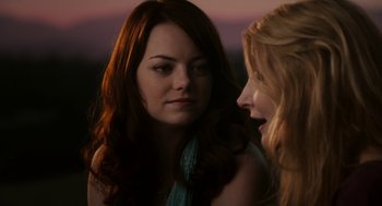 Movie still from “Easy A” (2010), directed by Will Gluck – Two women talking to each other in front of a sunset; Close Up shot, Over the shoulder angle