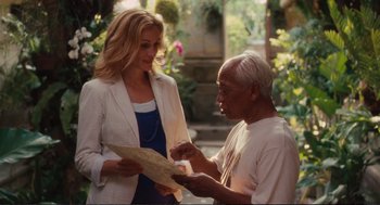 Movie still from “Eat Pray Love” (2010), directed by Ryan Murphy – An older man and a young woman looking at a piece of paper; Medium shot, Over the shoulder angle