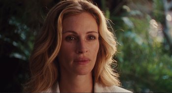 Movie still from “Eat Pray Love” (2010), directed by Ryan Murphy – A woman's face in front of trees; Close Up shot, Over the shoulder angle