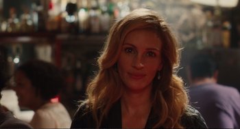 Movie still from “Eat Pray Love” (2010), directed by Ryan Murphy – A person with long blonde hair; Close Up shot, Over the shoulder angle