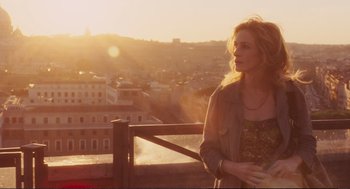 Movie still from “Eat Pray Love” (2010), directed by Ryan Murphy – A woman standing on top of a wooden fence; Medium shot, Over the shoulder angle