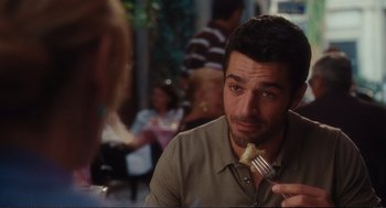 Movie still from “Eat Pray Love” (2010), directed by Ryan Murphy – A person holding a fork in his mouth; Close Up shot, Over the shoulder angle
