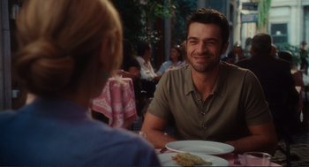 Movie still from “Eat Pray Love” (2010), directed by Ryan Murphy – A man sitting at a table with a plate of food in front of him; Medium shot, Over the shoulder angle