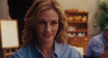 Movie still from “Eat Pray Love” (2010), directed by Ryan Murphy – A person wearing a blue shirt; Close Up shot, Over the shoulder angle