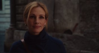 Movie still from “Eat Pray Love” (2010), directed by Ryan Murphy – A person wearing a jacket; Close Up shot, Over the shoulder angle