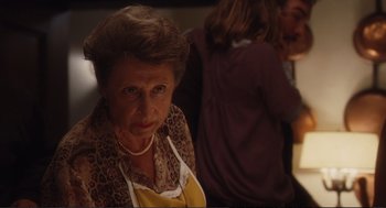 Movie still from “Eat Pray Love” (2010), directed by Ryan Murphy – An older woman wearing an animal print scarf; Close Up shot, Over the shoulder angle
