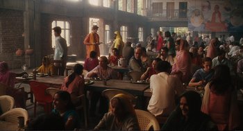 Movie still from “Eat Pray Love” (2010), directed by Ryan Murphy – A group of people sitting around a table; Wide shot, High angle