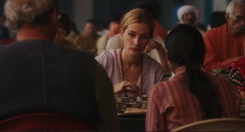 Movie still from “Eat Pray Love” (2010), directed by Ryan Murphy – A woman sitting at a table with a plate of food; Close Up shot, Over the shoulder angle