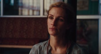 Movie still from “Eat Pray Love” (2010), directed by Ryan Murphy – A person wearing a blue shirt; Close Up shot, Over the shoulder angle