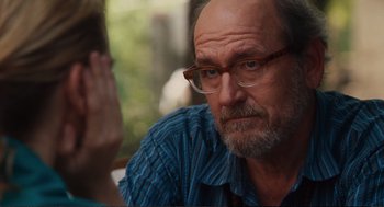 Movie still from “Eat Pray Love” (2010), directed by Ryan Murphy – An older man wearing glasses and a blue shirt; Close Up shot, Over the shoulder angle