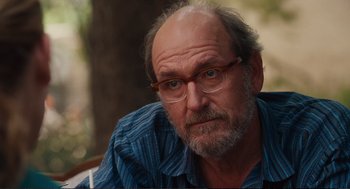 Movie still from “Eat Pray Love” (2010), directed by Ryan Murphy – An older man with a beard wearing glasses and a blue shirt; Close Up shot, Over the shoulder angle